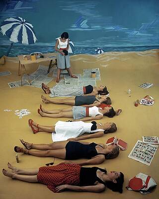 Wall Art - Photograph - Models Lying On A Fake Beach Set At A Studio by Serge Balkin