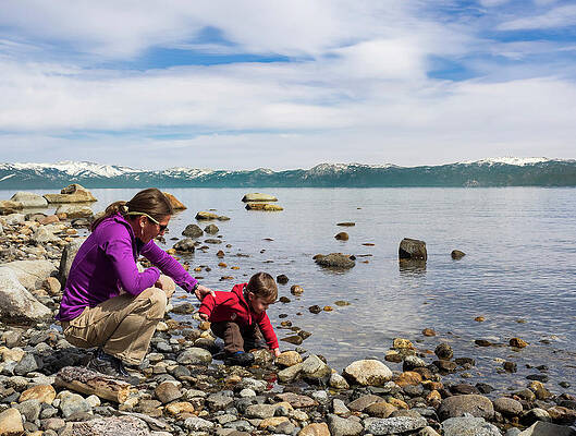 Wall Art - Photograph - Mother And Son Playing With Rocks by Josh Miller