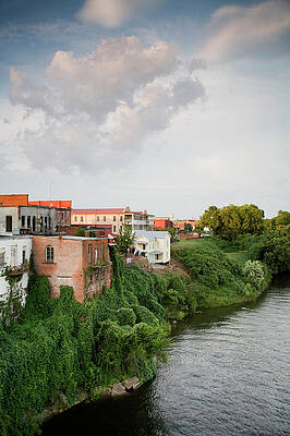 Wall Art - Photograph - Old Buildings Line A Slow Moving River by Michael Hanson