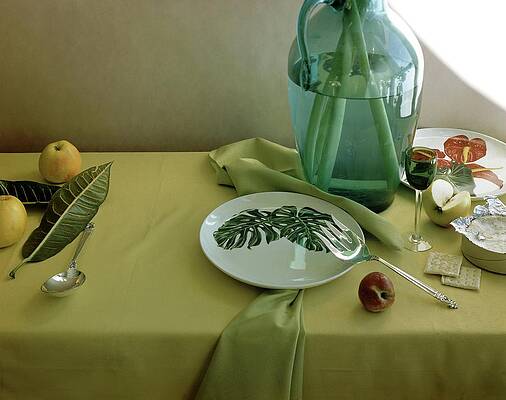 Wall Art - Photograph - Plates, Apples And A Vase On A Green Tablecloth by Horst P. Horst