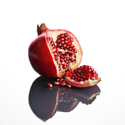 Wall Art - Photograph - Pomegranate opened up on reflective surface by Johan Swanepoel