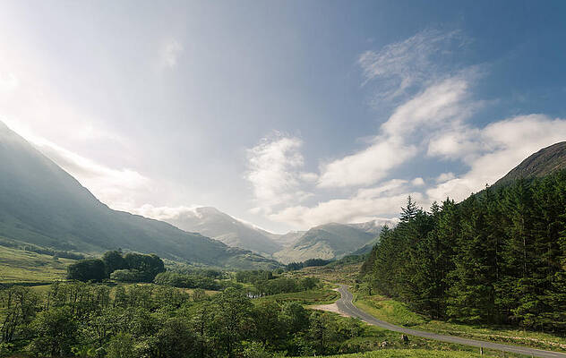 Road through a valley in the scottish highlands by Leander Nardin Road through a valley in the scottish highlands by Leander Nardin