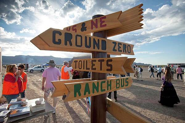 Wall Art - Photograph - Signpost And Tourists by Science Photo Library