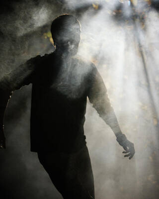 Wall Art - Photograph - Silhouette Of A Man Standing In Rays by Ron Koeberer