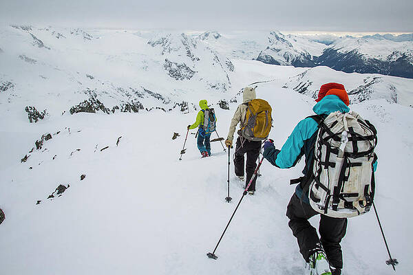Wall Art - Photograph - Skiers Descend A Ridge After Climbing by Michael Hanson