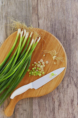 Wall Art - Photograph - Spring Onions On Chopping Board by Colin Anderson Productions Pty Ltd