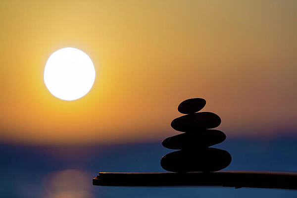 Wall Art - Photograph - Stack Of Pebbles With The Sun by Science Photo Library
