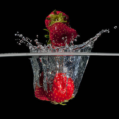 Strawberries splashing in water by Mike Santis Strawberries splashing in water by Mike Santis