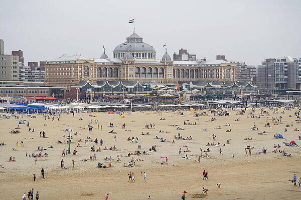 The beach with a backdrop of the Kurhaus in Scheveningen Netherlands by Ronald Wilfred Jansen