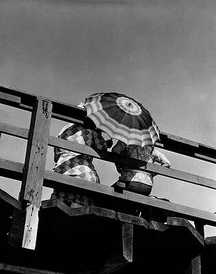 Wall Art - Photograph - Two People Under An Umbrella On A Boardwalk by Lusha Nelson
