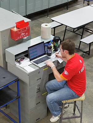 Wall Art - Photograph - Worker Using Laptop In A Factory by Science Photo Library