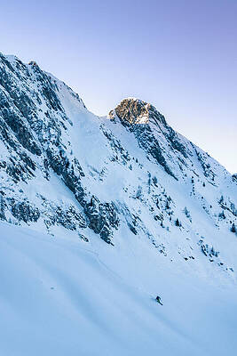 young male freerider skiing down a powder slope by Leander Nardin young male freerider skiing down a powder slope by Leander Nardin