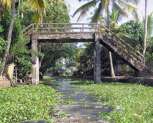 An old stone bridge over a canal in Alleppey by Ashish Agarwal An old stone bridge over a canal in Alleppey by Ashish Agarwal