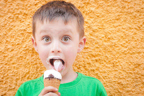 Wall Art - Photograph - Boy having ice cream by Tom Gowanlock