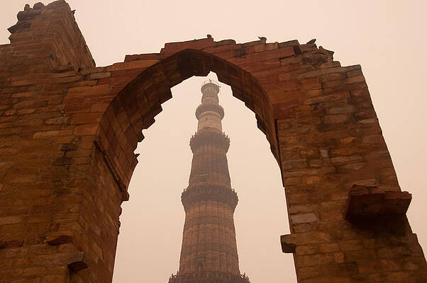 Cross section of the Qutub Minar framed within an archway in foggy weather by Ashish Agarwal Cross section of the Qutub Minar framed within an archway in foggy weather by Ashish Agarwal