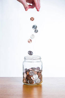Dropping Coins Into A Jar by Chris Edwards
