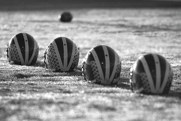 Helmets on Dew-Covered Field at Dawn Black and White by Michigan Helmet Helmets on Dew-Covered Field at Dawn Black and White by Michigan Helmet