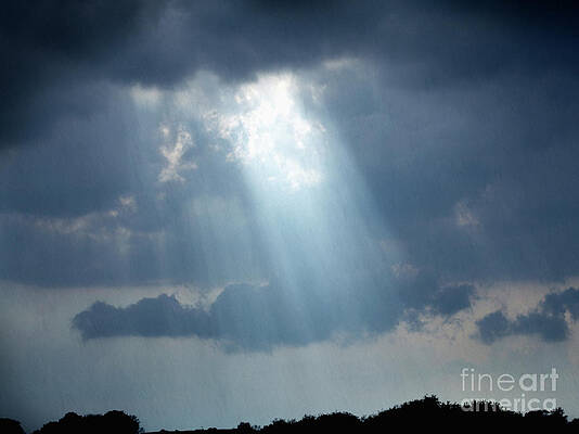 Rays of light coming through clouds as rain falls by Steven Puetzer