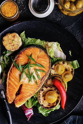 Wall Art - Photograph - Salmon Steak Baked On Coals With Vegetables On A Black Backgroun #1 by Cavan Images