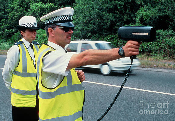 Wall Art - Photograph - Policeman Using Radar Gun To Detect Speeding Car #2 by Science Photo Library