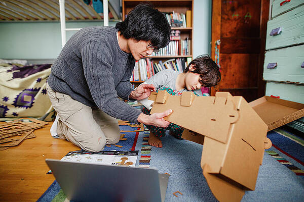 Wall Art - Photograph - A Dad And Son Build Structure Together With Cardboard by Cavan Images / Rebecca Tien