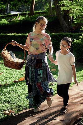 Wall Art - Photograph - A Mother And Her Daughter Walking Together In The Public Park by Cavan Images