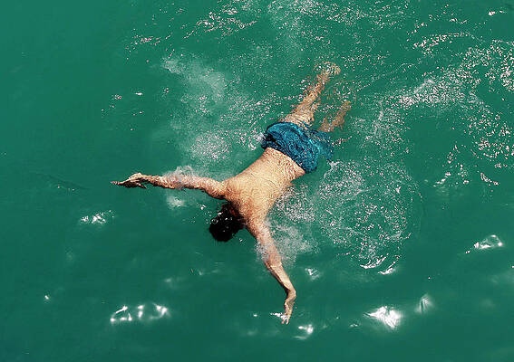 Wall Art - Photograph - An Afghan Man Swims in a Public by Omar Sobhani