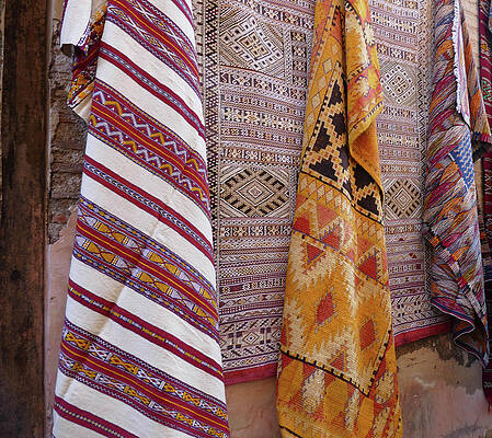 Wall Art - Photograph - Bright colored patterns on throw rugs in the medina bazaar  by Steve Estvanik