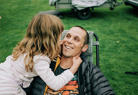 Wall Art - Photograph - Child Playing With Dads Cheeks Making Him Smile Whilst Camping by Cavan Images