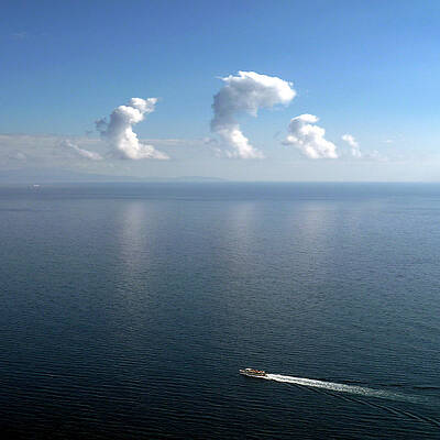 Clouds In Blue Sky Reflecting On Sea Print by Juliusjvloothuis