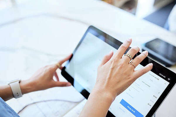 Wall Art - Photograph - Cropped Hands Of Female Using Digital Tablet At Checkout Counter by Cavan Images / Jack Jeffries