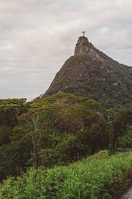Wall Art - Photograph - Distant View Of Christ The Redeemer On Mountain Against Cloudy Sky by Cavan Images
