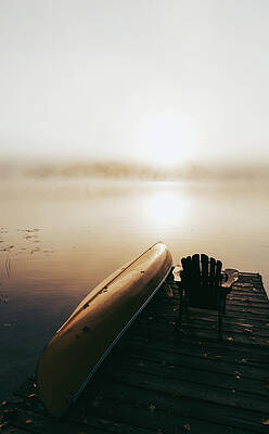 Wall Art - Photograph - Empty Dock With Overturned Canoe On A Foggy Morning On A Calm Lake. by Cavan Images