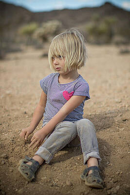 Wall Art - Photograph - Girl Frowns While Playing In The Dirt In Joshua Tree by Cavan Images