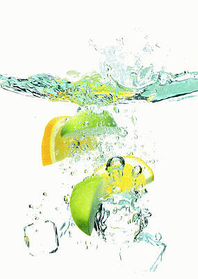 Wall Art - Photograph - Ice Cubes And Wedges Of  Lemon And Lime by Peter Dazeley