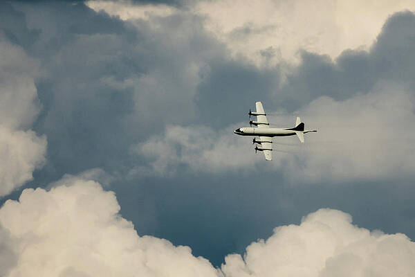Wall Art - Photograph - Lockheed P-3C Orion flying through the clouds by Scott Lyons