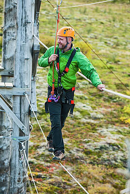 Wall Art - Photograph - Man Balancing On High Rope Obstacle Course In Iceland by Cavan Images