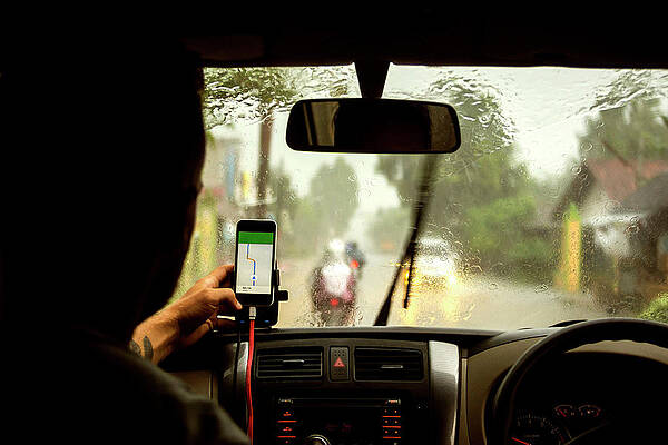 Wall Art - Photograph - Man Using Navigation Map On Mobile Phone While Sitting In Car by Cavan Images