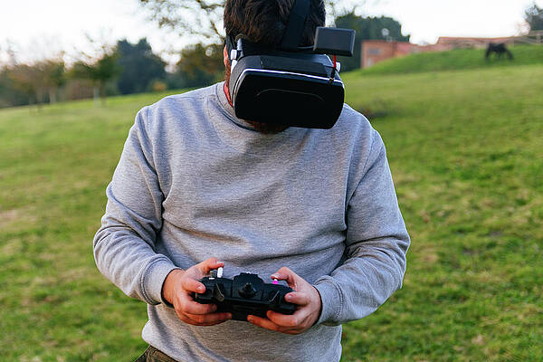 Wall Art - Photograph - Man With Virtual Reality Goggles And Drone Control Controller by Cavan Images