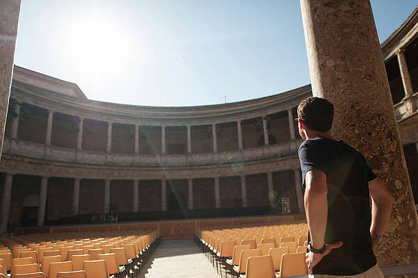 Wall Art - Photograph - Rear View Of Man With Hands On Hip Standing At Palace Of Charles V by Cavan Images