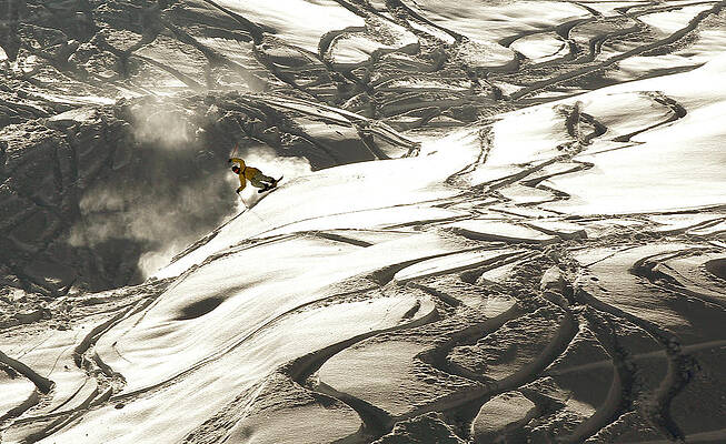 Wall Art - Photograph - Skiers Slide Down in Front of the Peak by Arnd Wiegmann