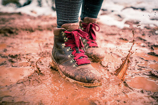 Wall Art - Photograph - Stylish Hiking Boot Splashing On Trail In Red Mud by Cavan Images