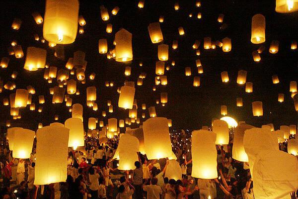 Wall Art - Photograph - Thais Gather to Release Floating by Sukree Sukplang