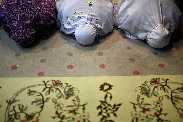 Wall Art - Photograph - Women Perform Prayers on the Evening by Stringer .