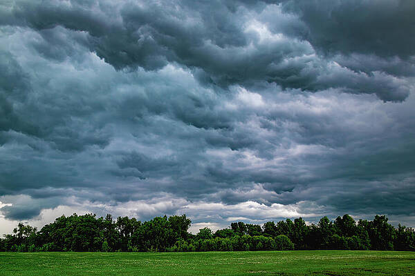 Wall Art - Photograph - A stormy sky with dark clouds and a field of grass #1 by Mike Worley