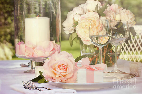 Small gift with pink rose on table by Sandra Cunningham Small gift with pink rose on table by Sandra Cunningham