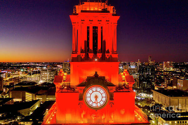 A closeup view of the iconic UT Clock Tower shining bright over the University of Texas Campus by Herronstock Prints A closeup view of the iconic UT Clock Tower shining bright over the University of Texas Campus by Herronstock Prints