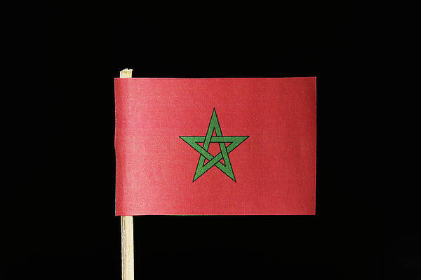 Wall Art - Photograph - A original and official flag of Morocco on toothpick on black background. Consists of a red field with the green pentagram, a five pointed linear star. by Vaclav Sonnek