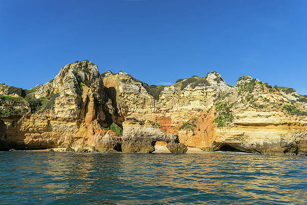 Algarve Gold Coast Sail - Boldly Colored Sea Cliffs with a Natural Arch in Lagos Portugal by Georgia Mizuleva Algarve Gold Coast Sail - Boldly Colored Sea Cliffs with a Natural Arch in Lagos Portugal by Georgia Mizuleva