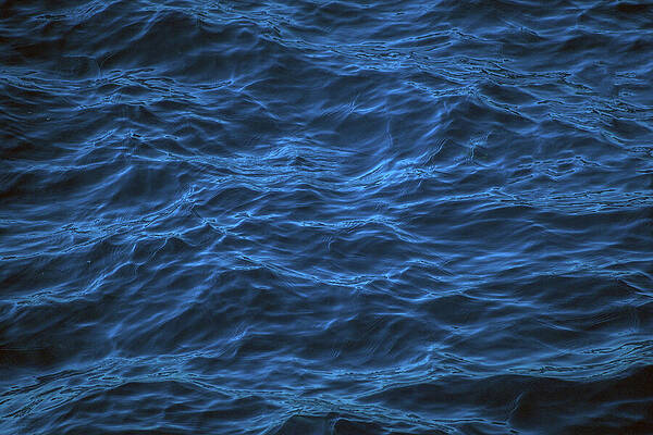 Wall Art - Photograph - An abstract background of seawater flow under light exposure by Arpan Bhatia